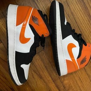 Orange and black retro mid Jordan 1s